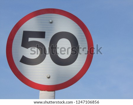 Traffic signs are limited to 50 km/h and blue sky. 