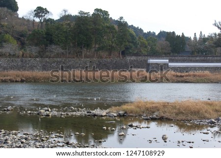 Kuma River flows by a historic castle site in Japan