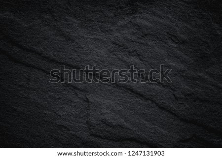 Dark grey black slate background or natural stone texture. Black stone wall.