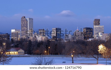 The glow before sunrise illuminates the Denver Colorado skyline in Winter.