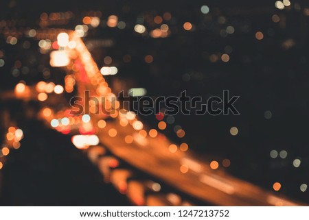 Abstract Defocused Blur of City Bokeh Lights at Twilight Scenery, Motion Blurred Street Vehicle Traffic and Urban Bokeh Illumination Effect Light. Blurry Abstract Background