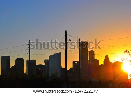 Downtown Houston’s skyscrapers create a silhouette against a late afternoon sky.