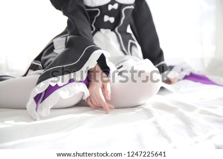 Portrait of Japan anime cosplay woman , white japanese maid in white tone room