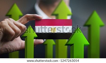 Nation Growth Concept, Green Up Arrows - Businessman Holding Card of Egypt Flag
