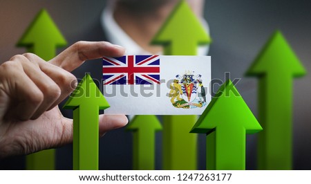 Nation Growth Concept, Green Up Arrows - Businessman Holding Card of British Antarctic Territory Flag