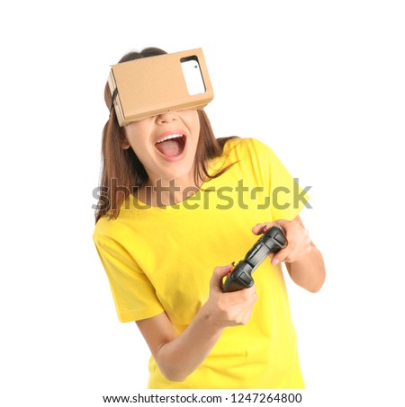Young woman using cardboard virtual reality headset, isolated on white