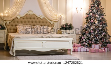 Bedroom with beige bed  and Christmas tree. Christmas interior. Royalty-Free Stock Photo #1247282821