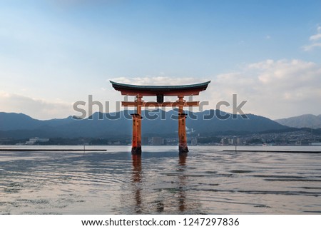 The famous torii giant torii gate at Itsukushima in Miyajima area of Hiroshima, Japan.  The sign on the gate reads "Itsukushima Shrine."