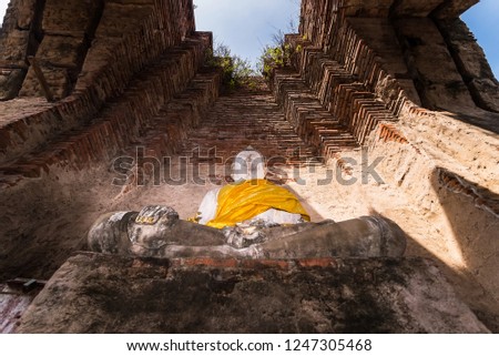 Old buddha statue with old wall brick of Wat Nakhon Luang Tample,Prasat Nakhon Luang in Ayutthaya,Thailand