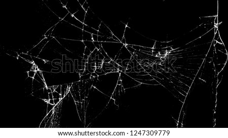 Texture of broken glass on a black background. Concept of broken automotive glass, screen phone, tablet, laptop. Flat lay, top view.