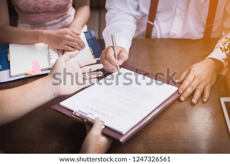 businessman signing contract and handshake after business negotiations to finally success