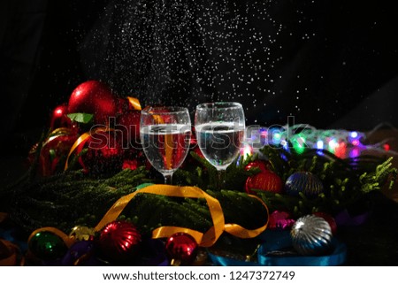 Two glasses of champagne with a Christmas decor in the background                       