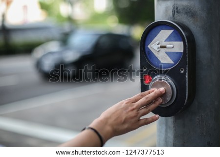Woman pressing the car stop button.