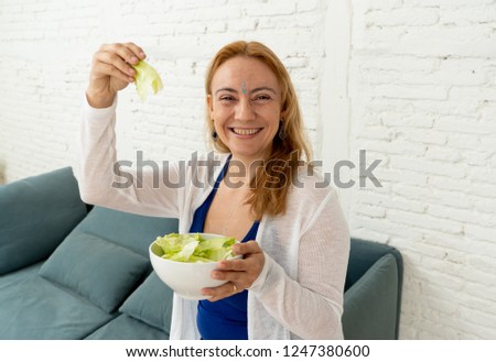 Cheerful woman showing bowl of green vegetable salad feeling happy of life change isolated on gray background in new lifestyle Ayurveda Diet Nutrition and Health beauty coach and Detox food concept. Royalty-Free Stock Photo #1247380600