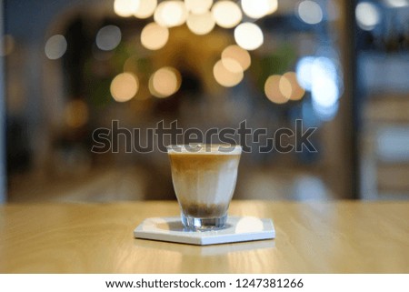 hot espresso coffee in a glass on light bokeh background