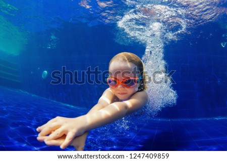 Happy family in swimming pool. Smiling child in goggles swim, dive in pool with fun - jump deep down underwater. Healthy lifestyle, people water sport activity, swimming lessons on holidays with kids Royalty-Free Stock Photo #1247409859