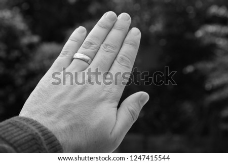 A Caucasian hand with a gold wedding ring. Marriage concept image.  