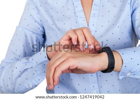 Close up picture of young female wearing mi fit band, checking her pulse & steps for the day