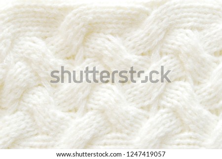 Ivory soft ornamental knitted pattern texture as background