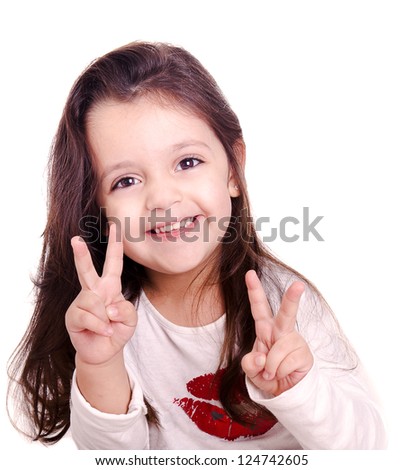 A cute kid girl making victory sign with her hands. This sign is also known as peace and love. The infant girl is isolated on white.