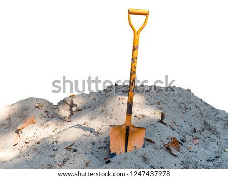 Old orange shovel On the pile of sand isolated on white background. With clipping path