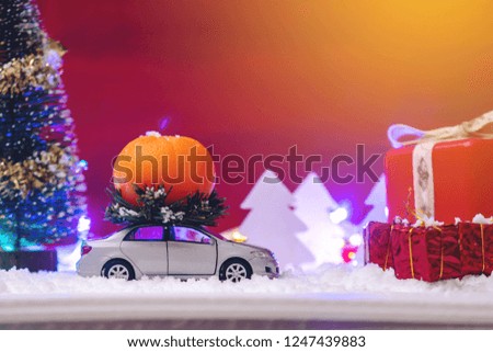 Toy car carries gifts in the Christmas and new year's eve on a blue background. The concept of holiday shopping and discounts