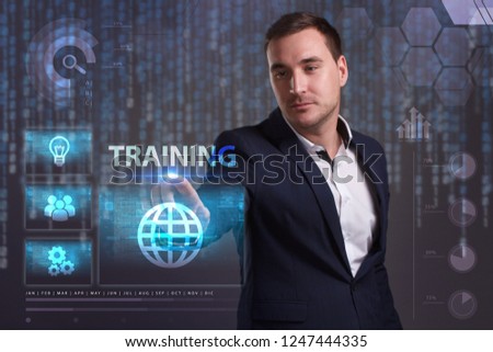 The concept of business, technology, the Internet and the network. A young entrepreneur working on a virtual screen of the future and sees the inscription: Training