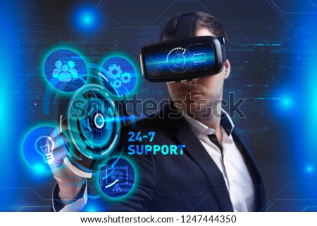 Business, Technology, Internet and network concept. Young businessman working in virtual reality glasses sees the inscription: 24-7 Support