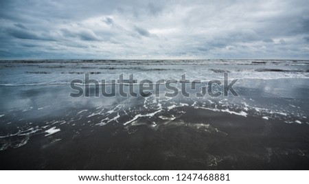 Caspian sea under blue sky in early September, snag on the beach