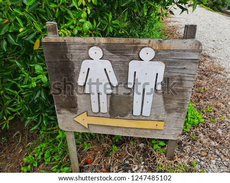 Wooden toilet signage in outdoor park