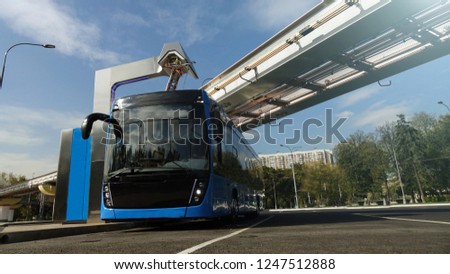 Blue electric bus at the charging station.Modern trains on the monorail.