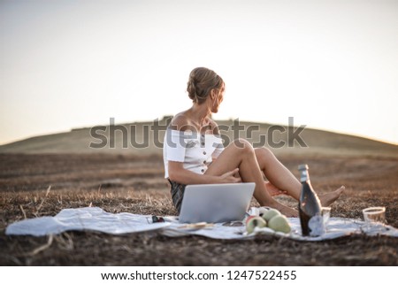 Blonde woman on an outdoor picnic.