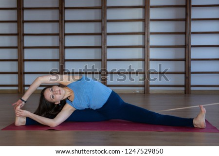 Young awesome happy woman developing flexibility. full length photo.yoga practise Calmness and relax, female happiness concept