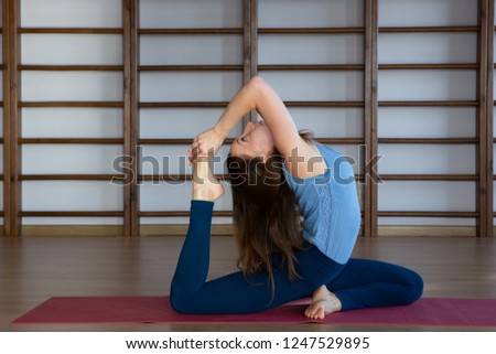 Beautiful photo of young lady standing in bridge exercise while practicing yoga poses on yoga mat Relaxation and meditation.