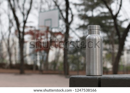 Insulated Stainless Bottle with a basketball hoop in winter background