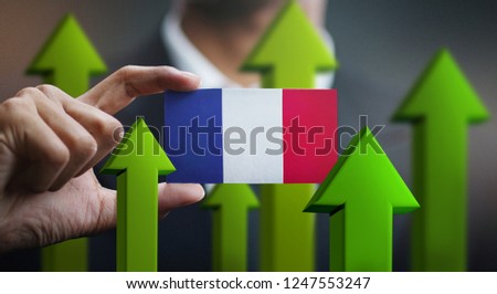 Nation Growth Concept, Green Up Arrows - Businessman Holding Card of France Flag