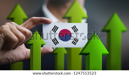 Nation Growth Concept, Green Up Arrows - Businessman Holding Card of South Korea Flag