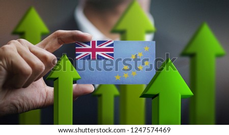 Nation Growth Concept, Green Up Arrows - Businessman Holding Card of Tuvalu Flag 