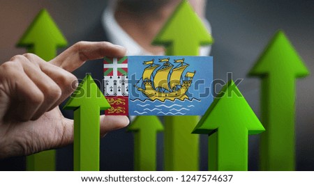 Nation Growth Concept, Green Up Arrows - Businessman Holding Card of Saint Pierre and Miquelon Flag