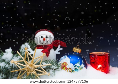 Christmas background with Christmas tree, snowman, candle, handmade snowflakes and balls on a snow. Night scene. Merry Christmas and happy new year.
