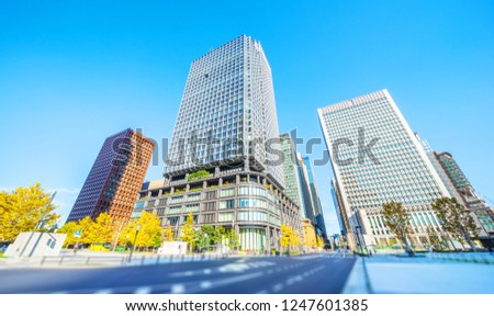 Asia Business concept for real estate and corporate construction - looking up view of modern city skyline with blue sky in tokyo, japan with tilt shift, miniature, blur effect