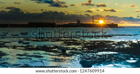 Lighthouse and sunset in Cadiz, "La Caleta". South Spain