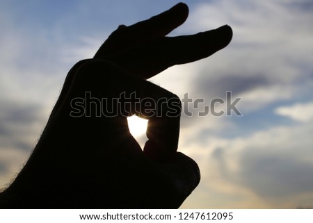 The hand on sky background