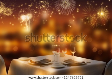 dinner table for two on foreground, blurred firework on background, festive lights at the party night, invitation for romantic banquet, concept with copy space