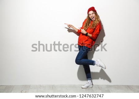Full length photo of adorable woman 20s wearing red clothes laughing while standing isolated over white background