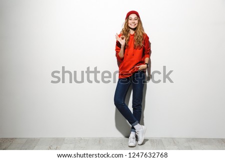 Full length photo of stylish woman 20s wearing red clothes laughing while standing isolated over white background