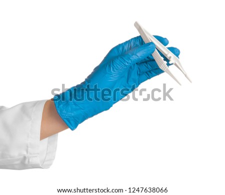 Doctor in medical glove with disposable forceps on white background