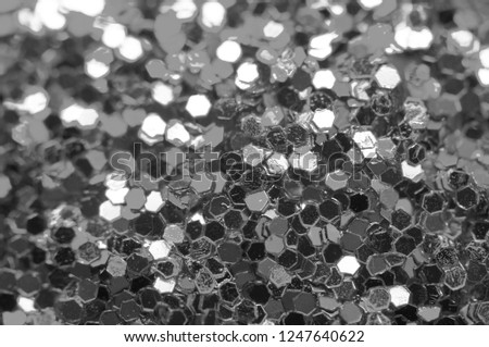 Beautiful Festive glitter of sparkles. Macro. Abstract black and white background.