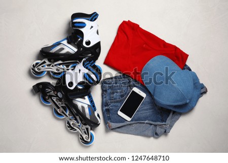 Flat lay composition with inline roller skates on light background