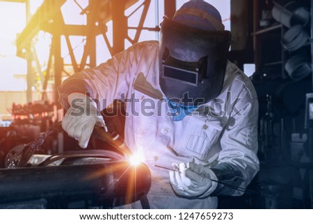 Tig welding Industrial worker at the factory welding close up